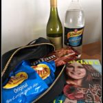 A Bag of chips, wine, chocolate, lemonade and magazine. A parody of a bug out bag for the apocalypse.