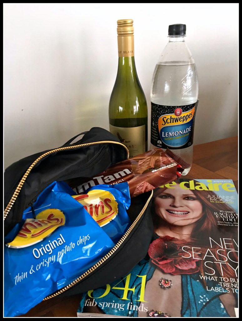A Bag of chips, wine, chocolate, lemonade and magazine. A parody of a bug out bag for the apocalypse.